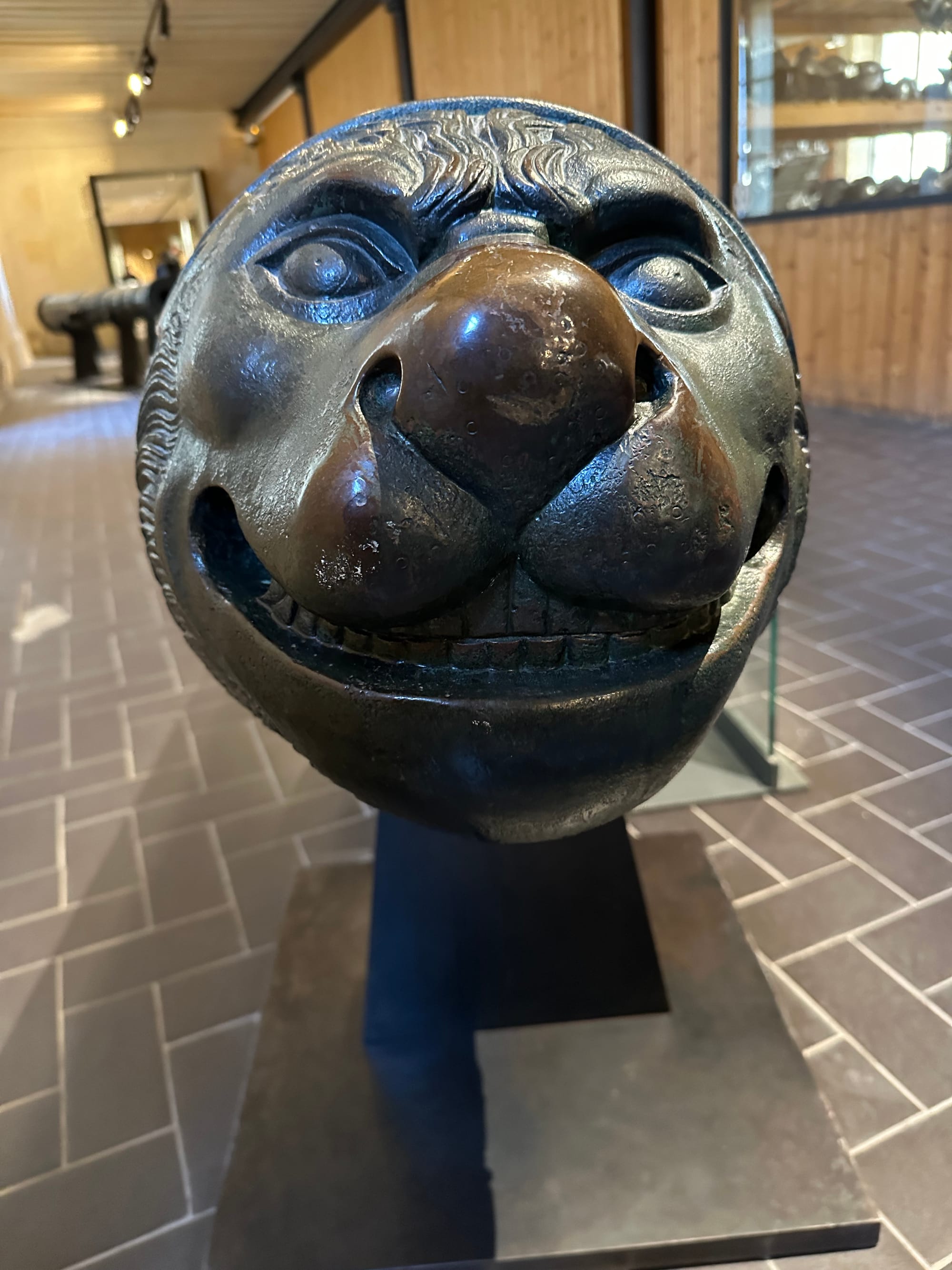 A grinning face on the back of a cannon.